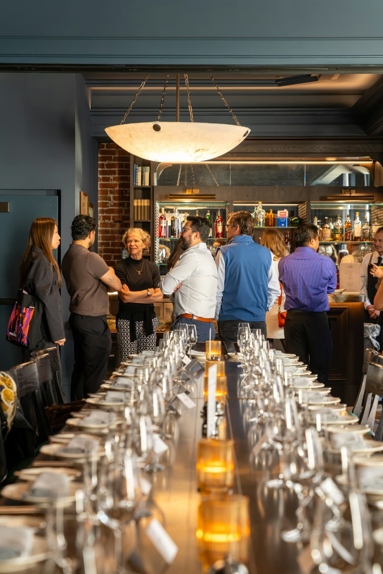 Professionals talking in a warm restaurant dining room.